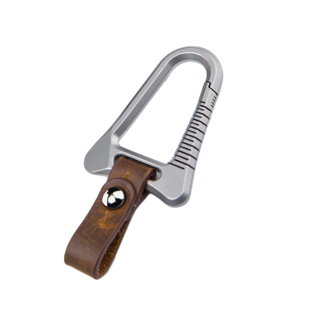 Silver carabiner with a brown leather strap on a white background