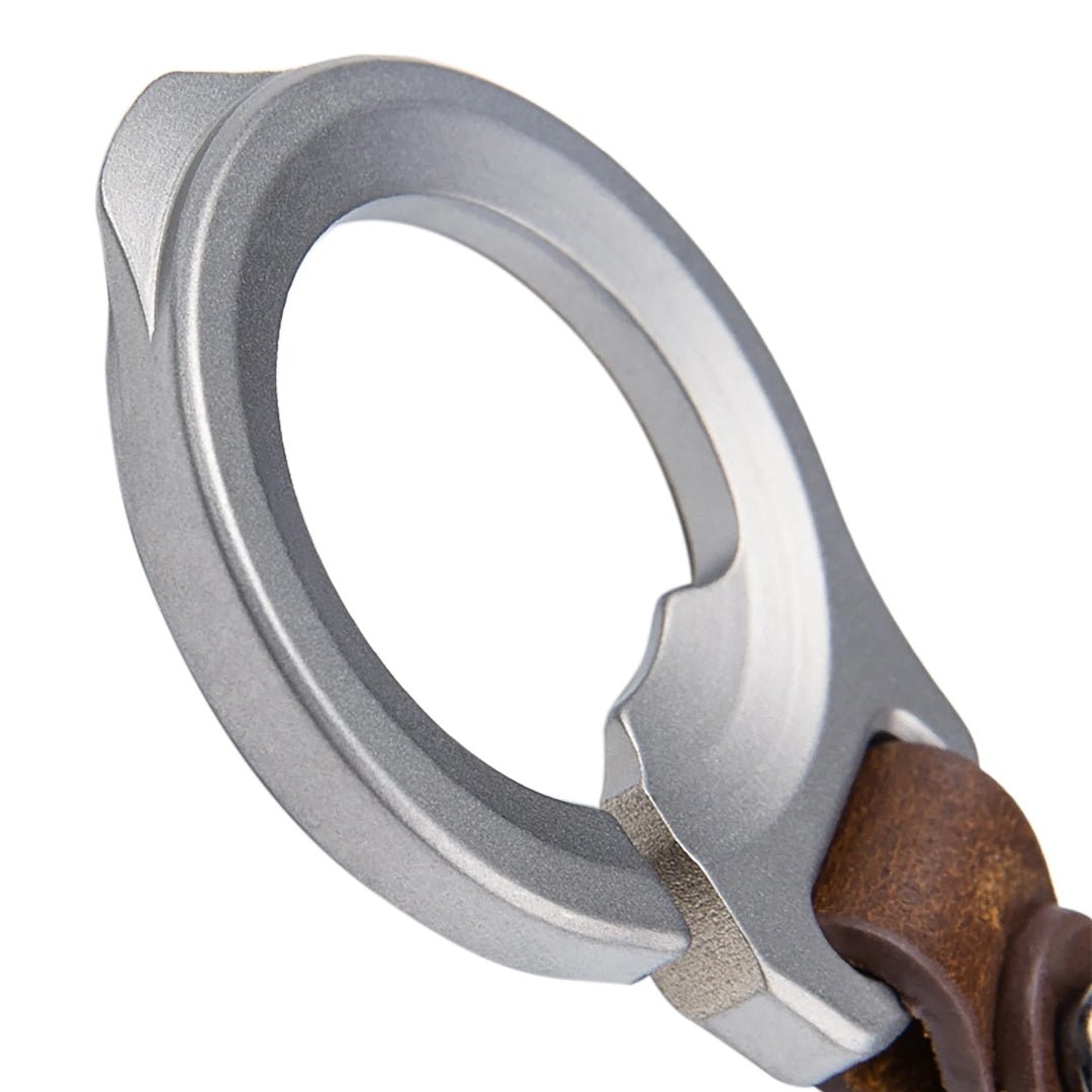 Close-up of a silver and brown bottle opener keychain on a white background