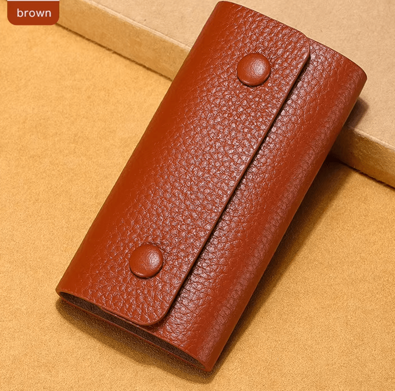 Brown leather wallet on a beige background
