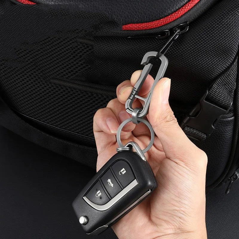 Keychain attached to a backpack holding car keys