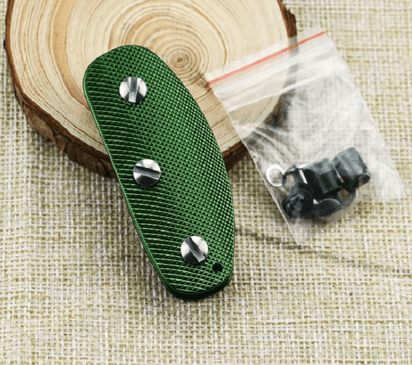 Green Key Holder with silver screws on a wooden surface