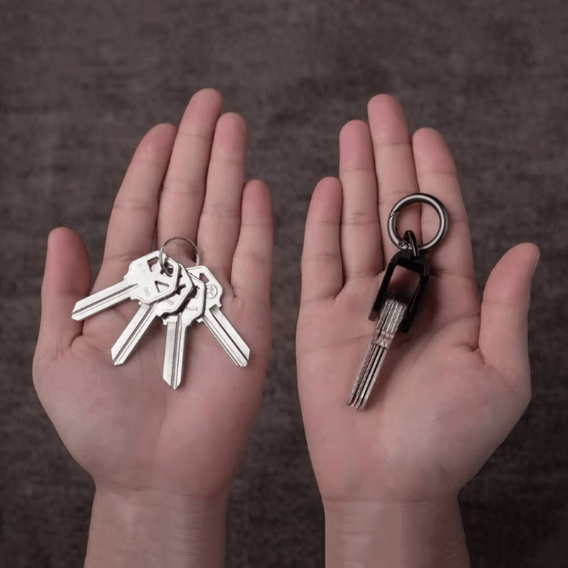 Two hands holding keys against a dark background, one with normal keychain, one with key organizer.