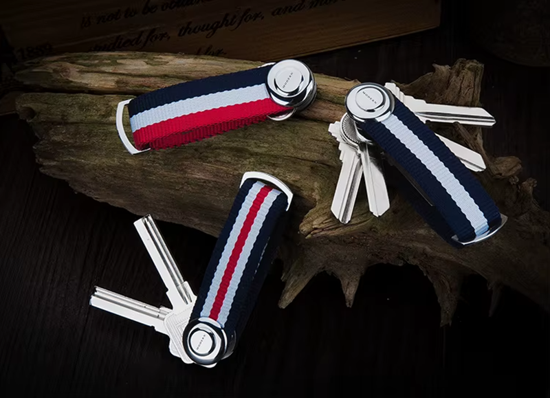 Keychain organizers with striped design on a wooden surface.