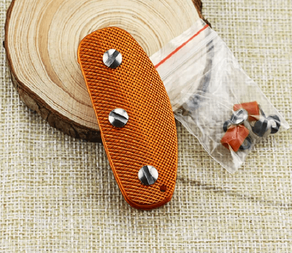 Orange Key holder with silver studs on a wooden surface