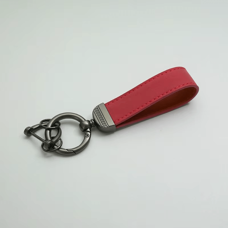 Red leather keychain with metal keyring on a light gray background
