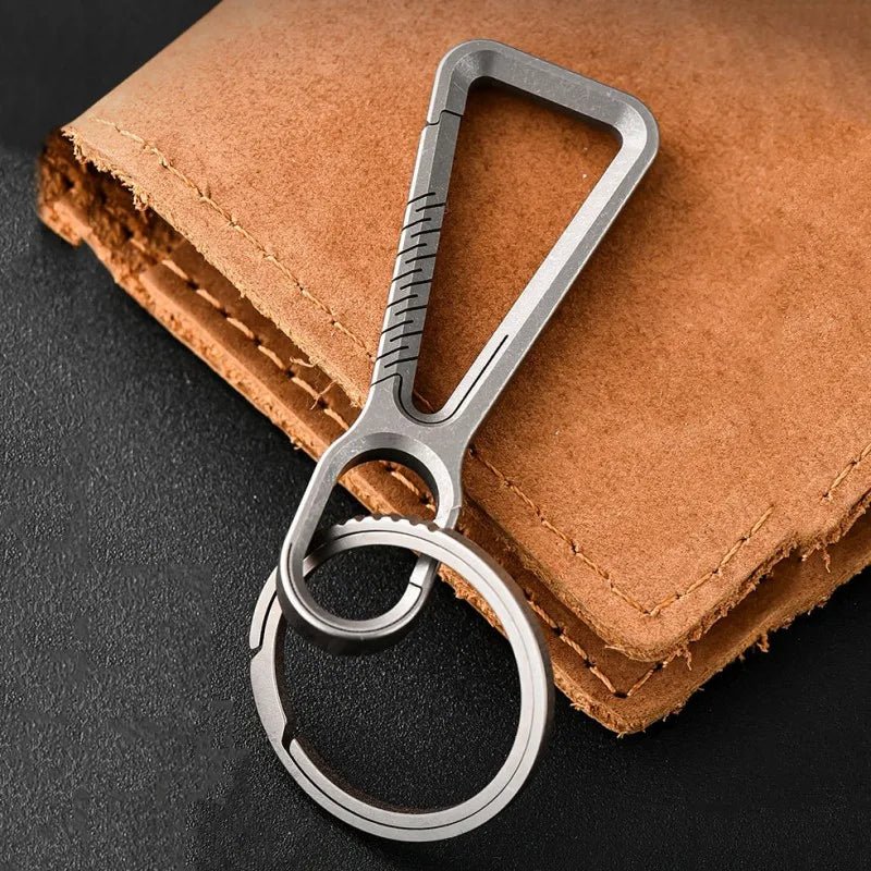 Titanium carabiner with matching titanium key ring on leather background