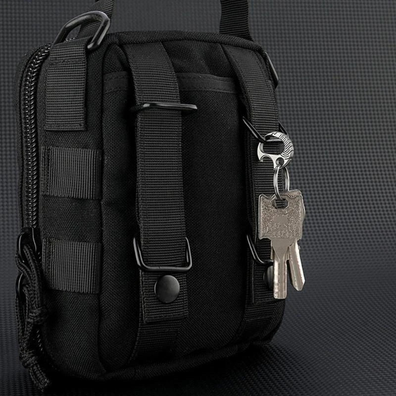 Black tactical bag with keys hanging off a titanium carabiner keychain on a dark textured background.