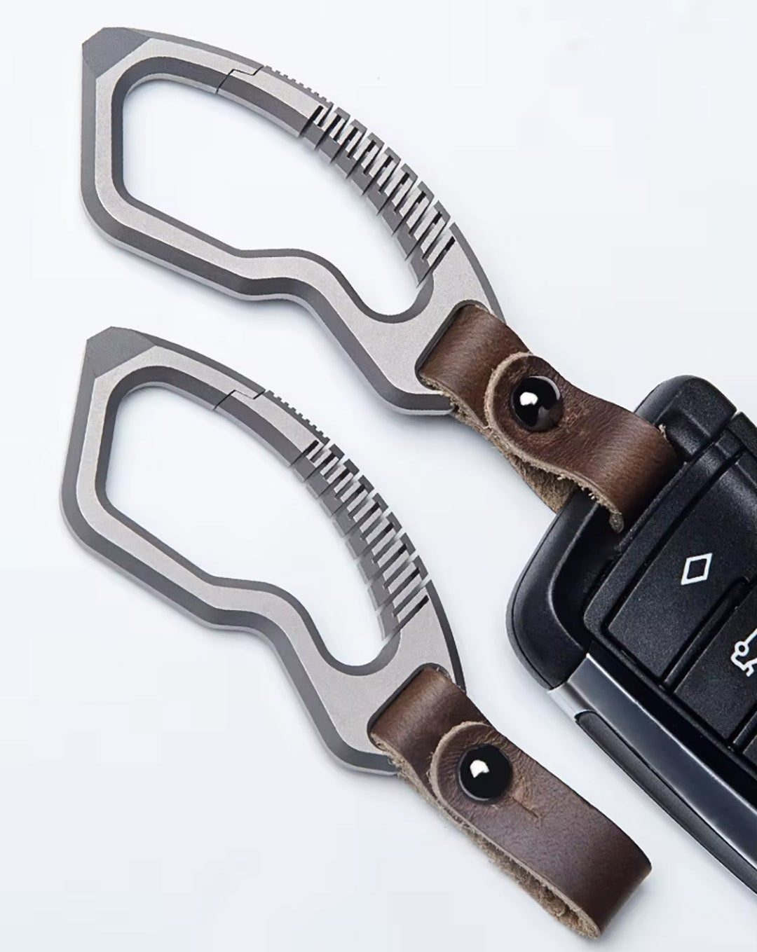 Titanium keychain with leather strap attached to car key