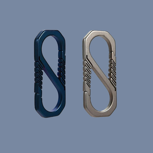 Blue and silver titanium S-shaped carabiners side by side on solid background