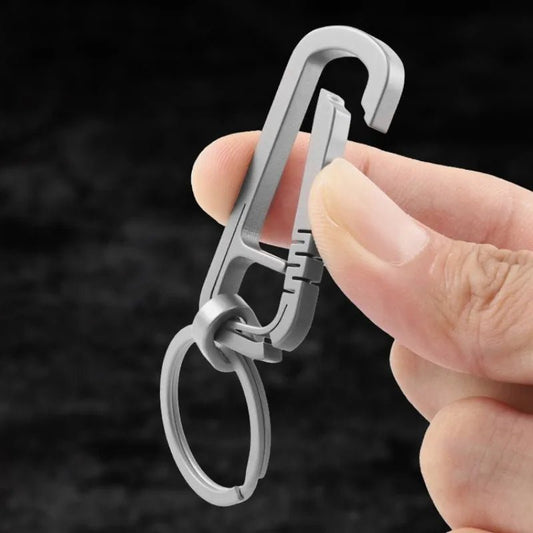 Close-up showing the quick-release mechanism of titanium carabiner