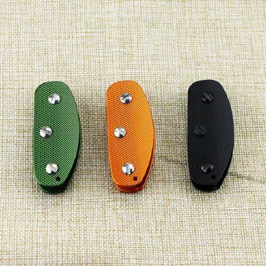Three Key Organizers in green, orange, and black on a textured beige background