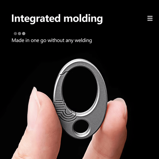 Hand holding a small titanium buckle showing integrated one-piece design