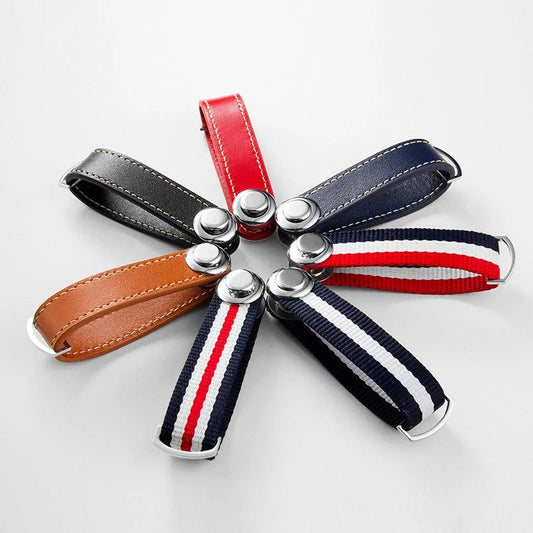 Set of keychains with different colored straps on a light gray background