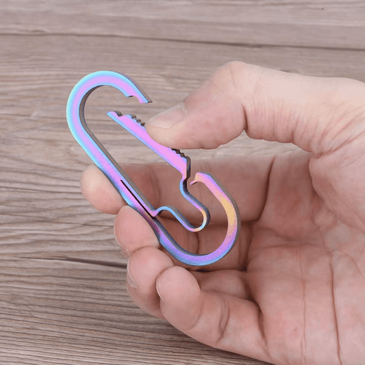 Titanium carabiner opened showing spring clip mechanism.