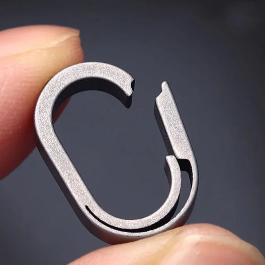 Close-up view showing precision quickdraw opening mechanism of titanium key ring